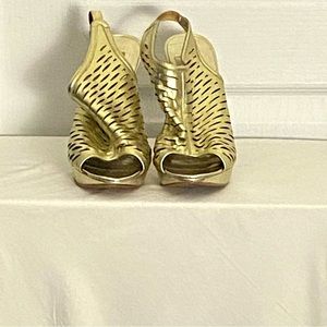 Size 10 gold platform caged sandals with little wear.